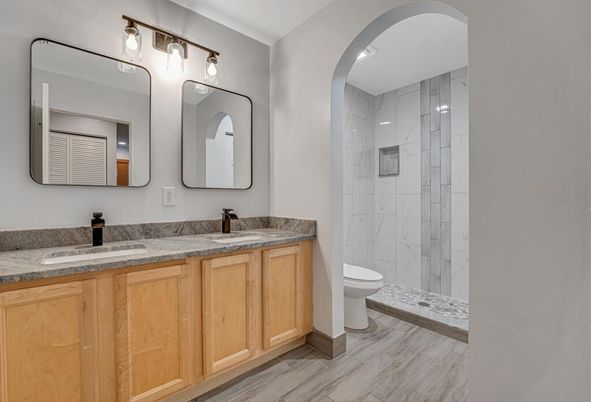 Bathroom, Dual Sink Vanities, Glass Shower, Interior, Marble Walls, Wood Texture Flooring