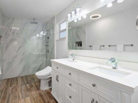 Bathroom, Dual Sink Vanities, Glass Shower, Interior, Marble Walls, Recessed Lighting, Wood Texture Flooring