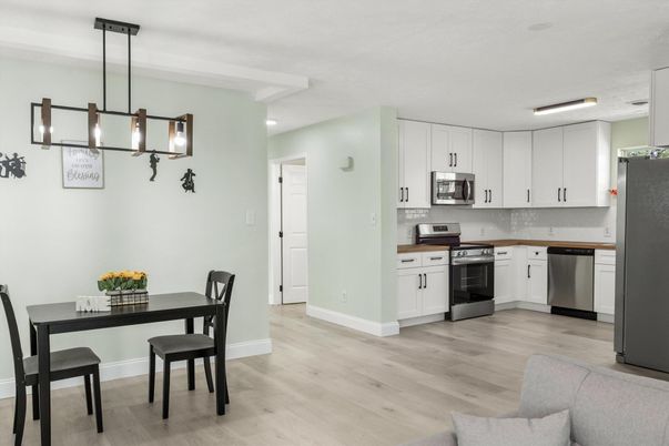 Dining room, Interior, Kitchen, Pendant Lights, Recessed Lighting, Stainless Steel Appliances, Wood Texture Flooring