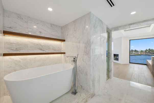 Bathroom, Free Standing Baths, Interior, Marble, Marble Walls, Recessed Lighting, Water, Wood Texture Flooring