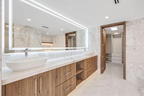 Bathroom, Dual Sink Vanities, Interior, Marble, Marble Walls, Recessed Lighting, Walk-in Closets