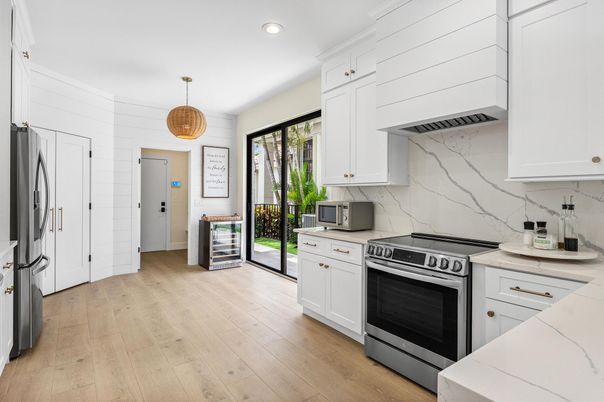 Interior, Kitchen, Marble Walls, Pendant Lights, Recessed Lighting, Stainless Steel Appliances, Wood Texture Flooring