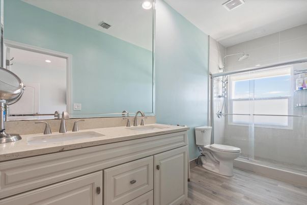 Bathroom, Dual Sink Vanities, Glass Shower, Interior, Recessed Lighting, Wood Texture Flooring