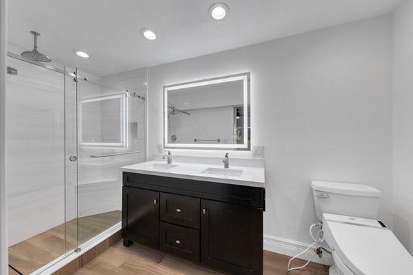 Bathroom, Dual Sink Vanities, Glass Shower, Interior, Recessed Lighting, Wood Texture Flooring