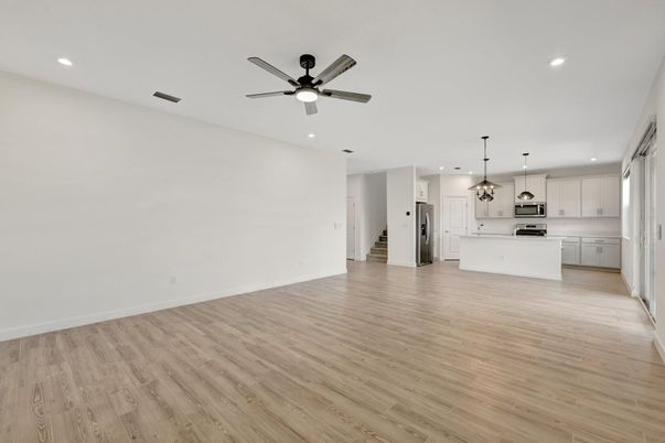 Empty room, Interior, Kitchen, Pendant Lights, Recessed Lighting, Stainless Steel Appliances, Wood Texture Flooring