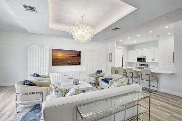 Chandelier, Interior, Kitchen, Living room, Pendant Lights, Recessed Lighting, Stainless Steel Appliances, Wood Texture Flooring