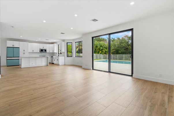 Empty room, Interior, Kitchen, Recessed Lighting, Stainless Steel Appliances, Wood Texture Flooring
