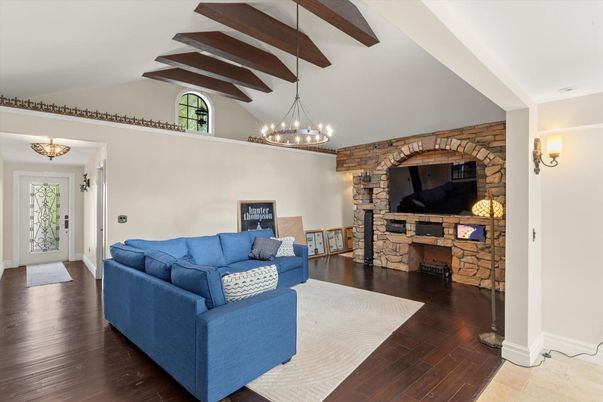 Chandelier, Fireplace, Interior, Living room, Stone Walls, Wooden Beams, Wood Texture Flooring