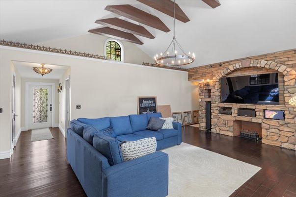 Chandelier, Fireplace, Interior, Living room, Stone Walls, Wooden Beams, Wood Texture Flooring