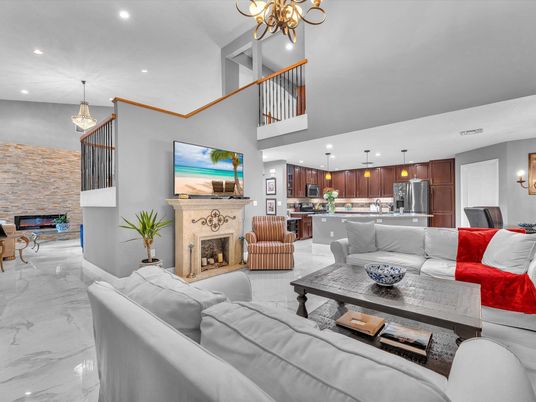 Chandelier, Dining room, Fireplace, Interior, Kitchen, Living room, Marble, Pendant Lights, Recessed Lighting, Stainless Steel Appliances, Stone Walls