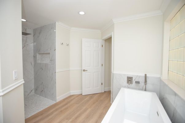 Bathroom, Free Standing Baths, Interior, Marble Walls, Recessed Lighting, Wood Texture Flooring