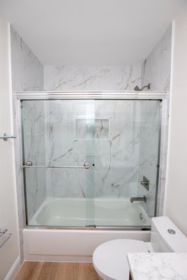 Bathroom, Glass Shower, Interior, Marble Walls, Wood Texture Flooring