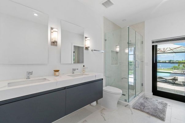 Bathroom, Dual Sink Vanities, Glass Shower, Interior, Marble, Marble Walls, Recessed Lighting