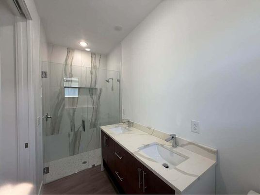 Bathroom, Dual Sink Vanities, Glass Shower, Interior, Recessed Lighting, Wood Texture Flooring