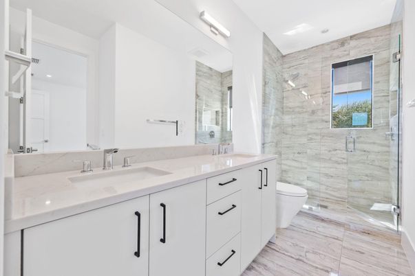 Bathroom, Dual Sink Vanities, Glass Shower, Interior, Marble Walls, Recessed Lighting, Wood Texture Flooring