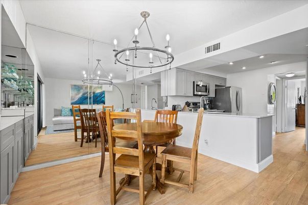 Chandelier, Dining room, Interior, Kitchen, Pendant Lights, Recessed Lighting, Stainless Steel Appliances, Wood Texture Flooring