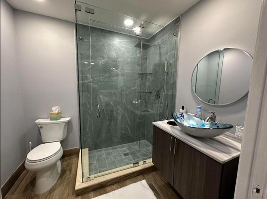 Bathroom, Glass Shower, Interior, Marble Walls, Recessed Lighting, Wood Texture Flooring