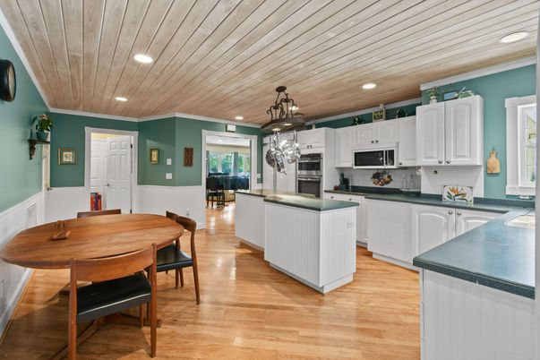 Chandelier, Dining room, Interior, Kitchen, Pendant Lights, Recessed Lighting, Stainless Steel Appliances, Wooden Ceilings, Wood Texture Flooring