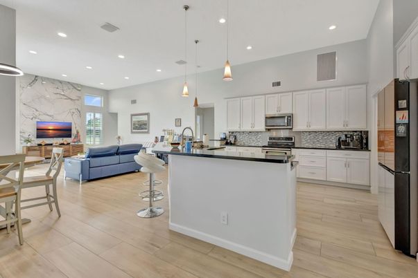 Interior, Kitchen, Living room, Marble Walls, Pendant Lights, Recessed Lighting, Stainless Steel Appliances, Wood Texture Flooring