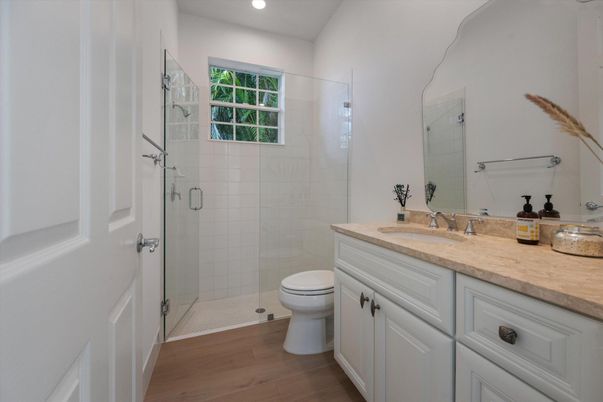 Bathroom, Dual Sink Vanities, Glass Shower, Interior, Recessed Lighting, Wood Texture Flooring