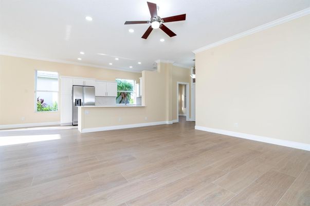 Empty room, Interior, Kitchen, Recessed Lighting, Stainless Steel Appliances, Wood Texture Flooring