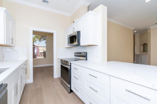 Interior, Kitchen, Marble Walls, Recessed Lighting, Stainless Steel Appliances, Wood Texture Flooring