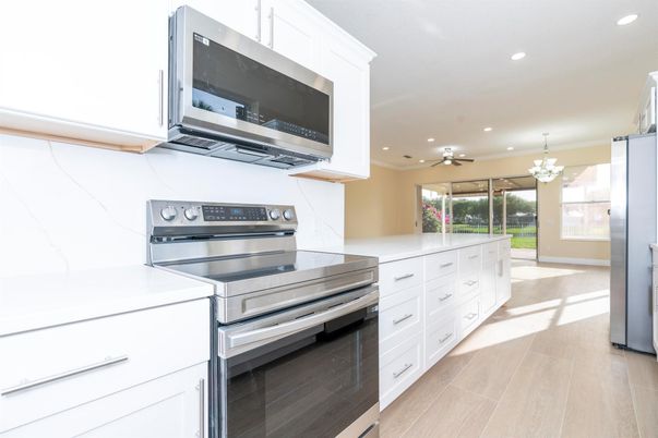 Chandelier, Interior, Kitchen, Marble Walls, Recessed Lighting, Stainless Steel Appliances, Wood Texture Flooring