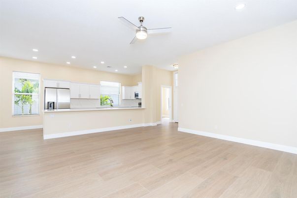 Empty room, Interior, Kitchen, Recessed Lighting, Stainless Steel Appliances, Wood Texture Flooring