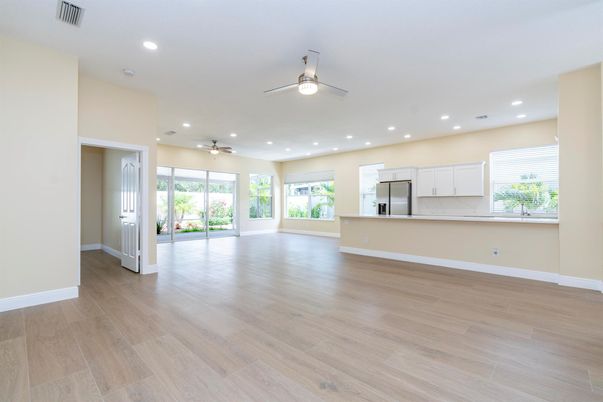 Empty room, Interior, Kitchen, Recessed Lighting, Stainless Steel Appliances, Wood Texture Flooring