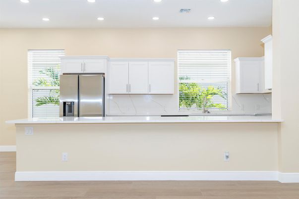 Interior, Kitchen, Marble Walls, Recessed Lighting, Stainless Steel Appliances, Wood Texture Flooring