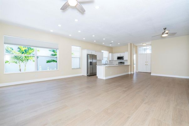 Empty room, Interior, Kitchen, Recessed Lighting, Stainless Steel Appliances, Wood Texture Flooring