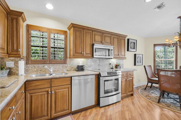 Chandelier, Dining room, Interior, Kitchen, Recessed Lighting, Stainless Steel Appliances, Wood Texture Flooring