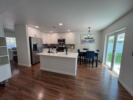 Dining room, Interior, Kitchen, Pendant Lights, Recessed Lighting, Stainless Steel Appliances, Wood Texture Flooring