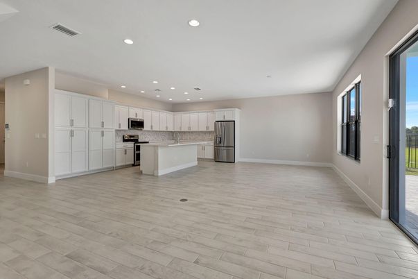 Empty room, Interior, Kitchen, Recessed Lighting, Stainless Steel Appliances, Wood Texture Flooring