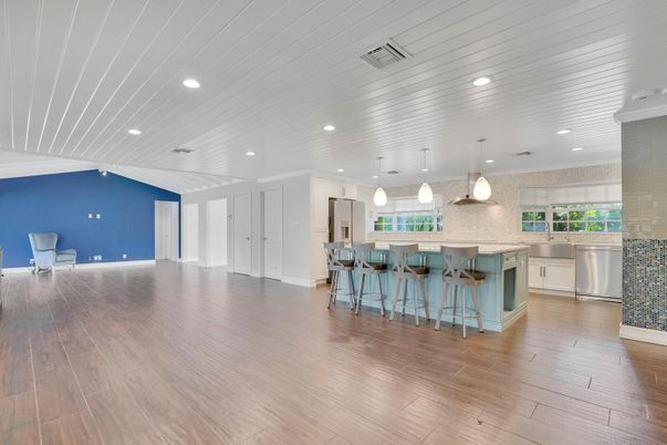 Empty room, Interior, Kitchen, Pendant Lights, Recessed Lighting, Stainless Steel Appliances, Wood Texture Flooring