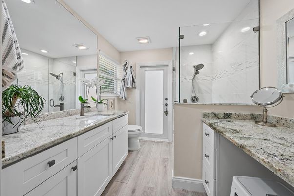 Bathroom, Dual Sink Vanities, Glass Shower, Interior, Marble Walls, Recessed Lighting, Wood Texture Flooring