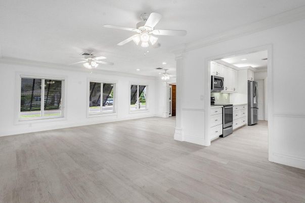 Empty room, Interior, Kitchen, Recessed Lighting, Stainless Steel Appliances, Wood Texture Flooring