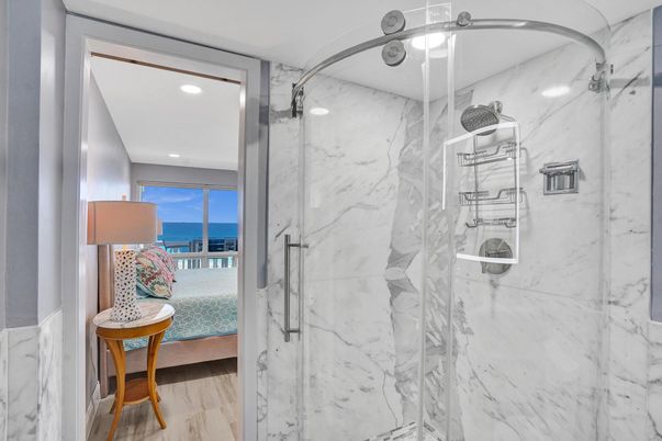 Bathroom, Glass Shower, Interior, Marble Walls, Recessed Lighting, Water, Wood Texture Flooring