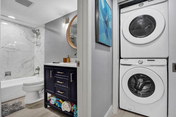 Bathroom, Interior, Marble Walls, Recessed Lighting, Utility Closets, Washer, Wood Texture Flooring