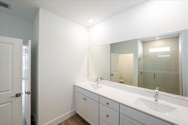 Bathroom, Dual Sink Vanities, Glass Shower, Interior, Recessed Lighting, Wood Texture Flooring