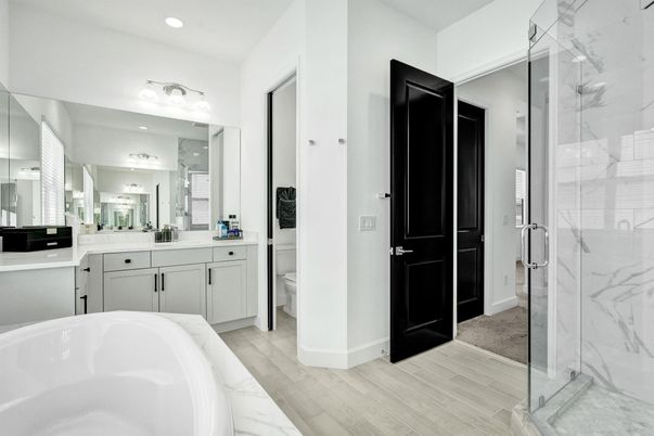 Bathroom, Dual Sink Vanities, Glass Shower, Interior, Marble Walls, Recessed Lighting, Wood Texture Flooring