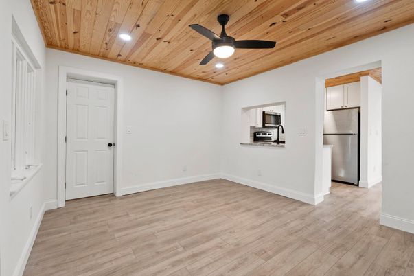 Empty room, Interior, Kitchen, Recessed Lighting, Stainless Steel Appliances, Wooden Ceilings, Wood Texture Flooring