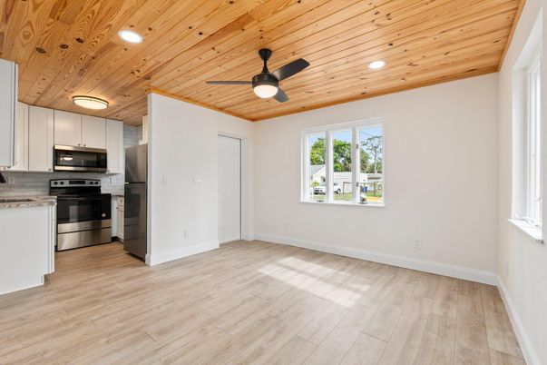 Empty room, Interior, Kitchen, Recessed Lighting, Stainless Steel Appliances, Wooden Ceilings, Wood Texture Flooring