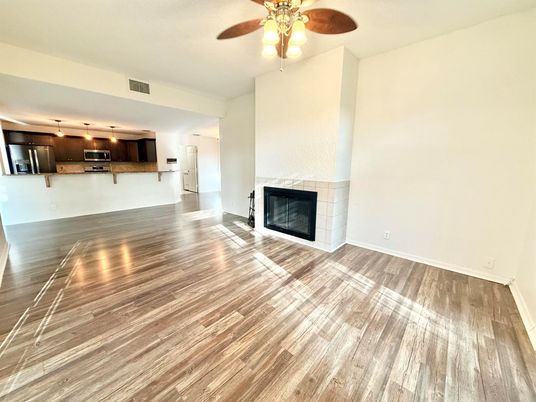 Empty room, Fireplace, Interior, Kitchen, Stainless Steel Appliances, Wood Texture Flooring