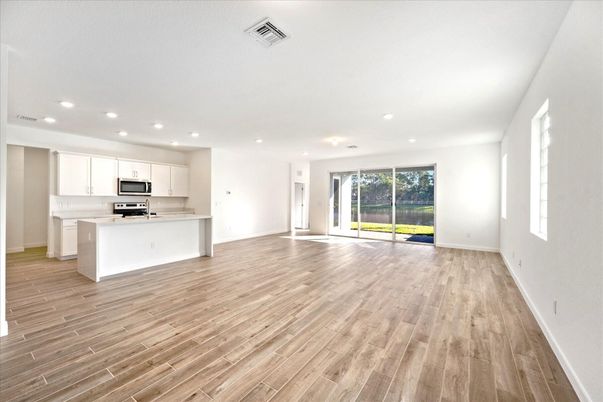 Empty room, Interior, Kitchen, Recessed Lighting, Stainless Steel Appliances, Wood Texture Flooring
