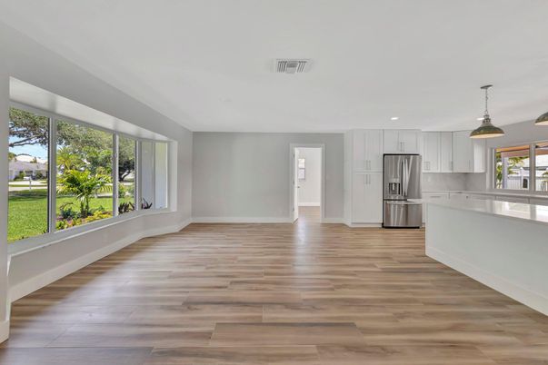 Empty room, Interior, Kitchen, Pendant Lights, Recessed Lighting, Stainless Steel Appliances, Wood Texture Flooring