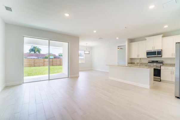 Empty room, Interior, Kitchen, Pendant Lights, Recessed Lighting, Stainless Steel Appliances, Wood Texture Flooring