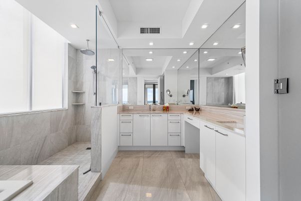 Bathroom, Dual Sink Vanities, Glass Shower, Interior, Marble Walls, Recessed Lighting, Wood Texture Flooring