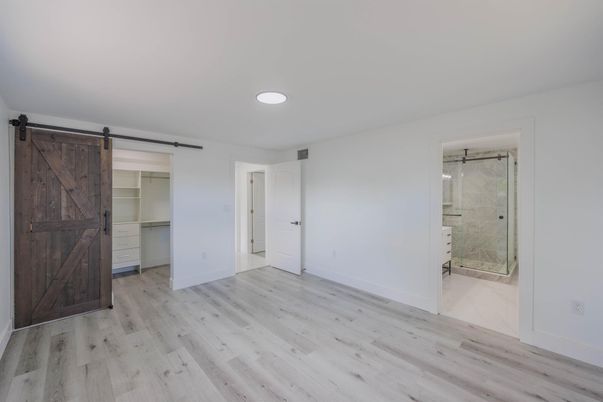 Bathroom, Empty room, Glass Shower, Interior, Marble Walls, Recessed Lighting, Wood Texture Flooring