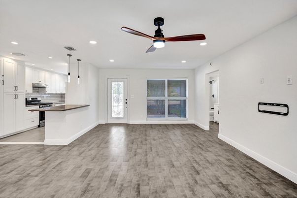 Empty room, Interior, Kitchen, Pendant Lights, Recessed Lighting, Stainless Steel Appliances, Wood Texture Flooring